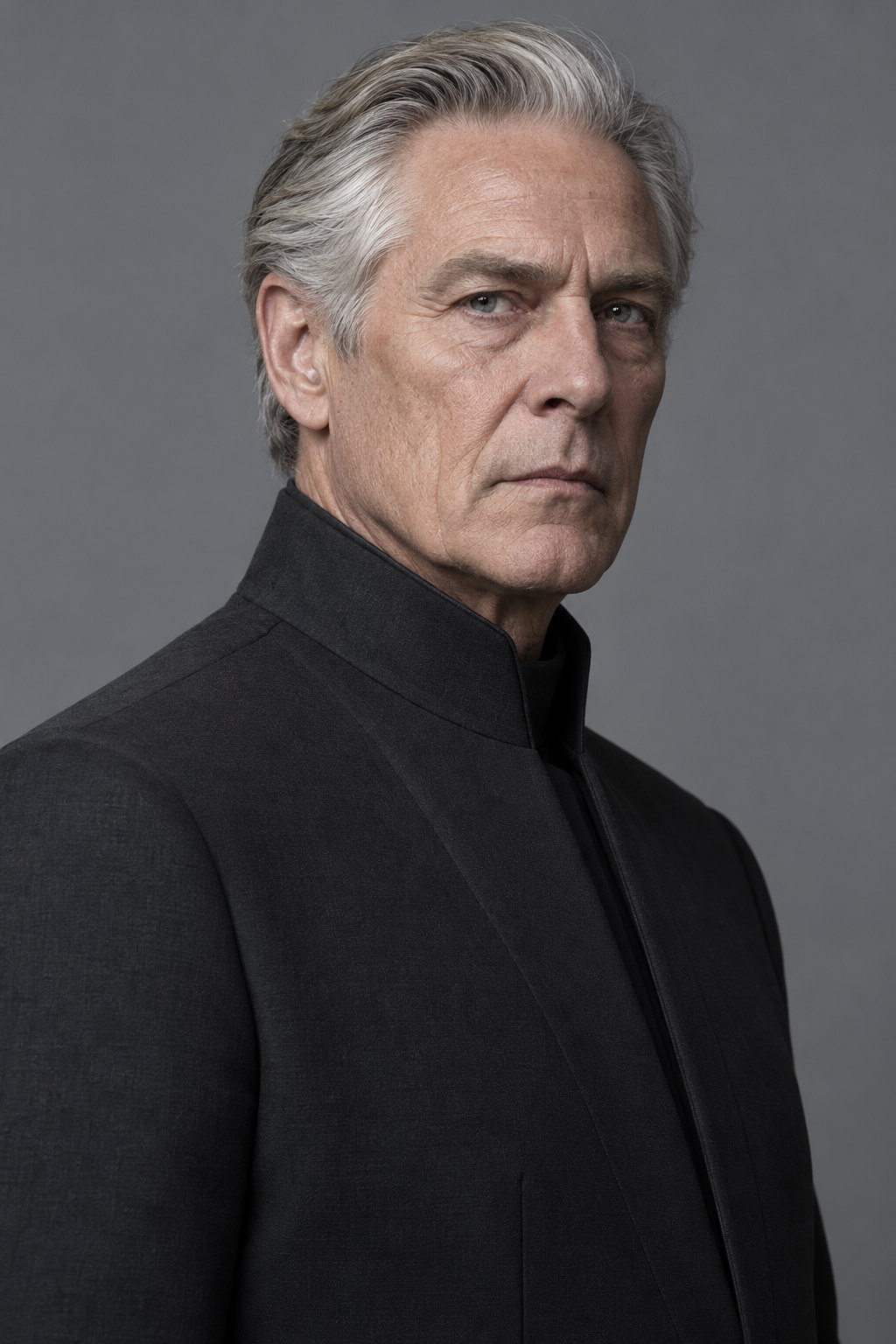 Chancellor Orson Voss, a silver-haired man in a severe black high-collared uniform coat, standing against a dark grey background and looking straight at the camera.